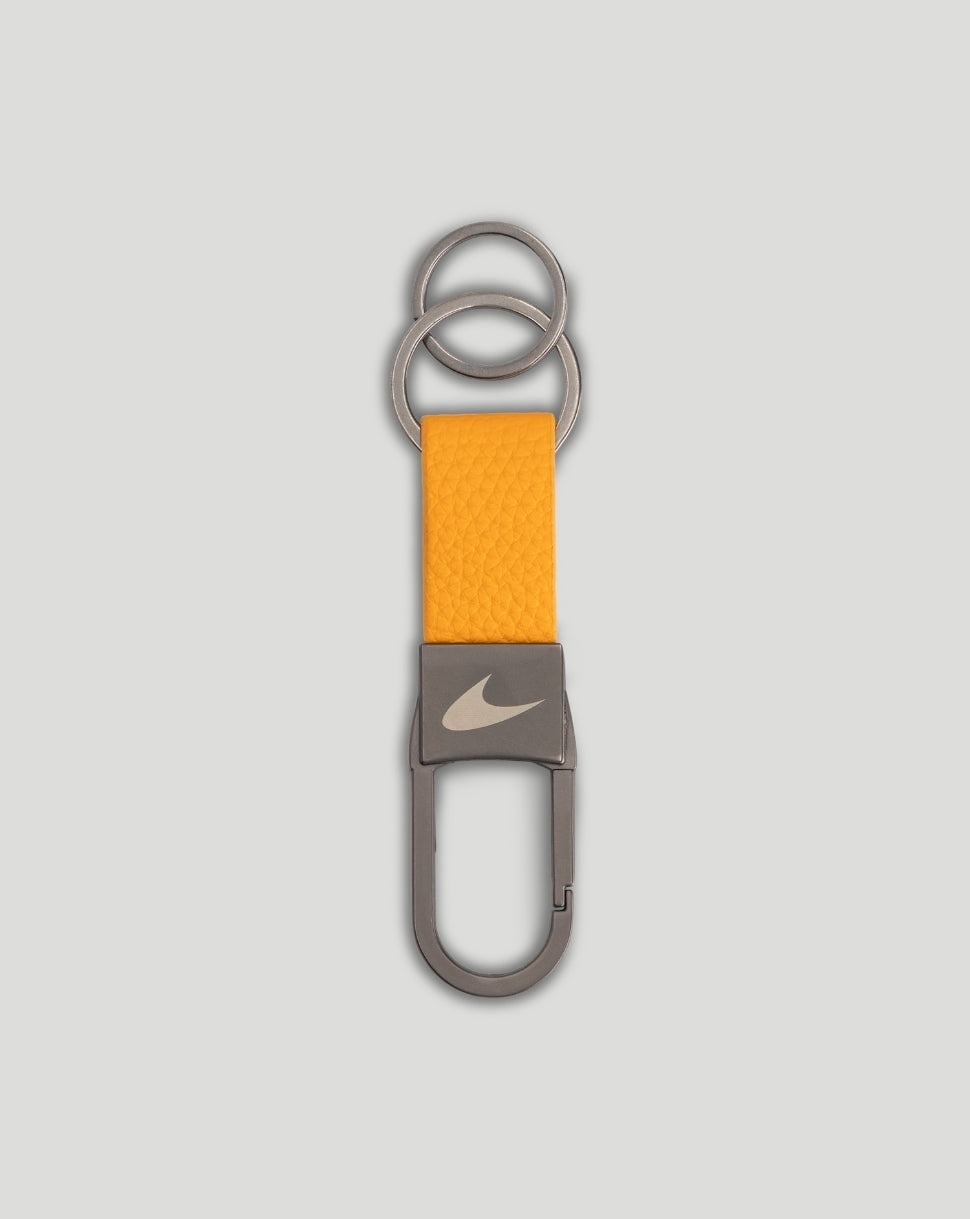 Orange textured strap key ring with gray metal clip and Nike swoosh.