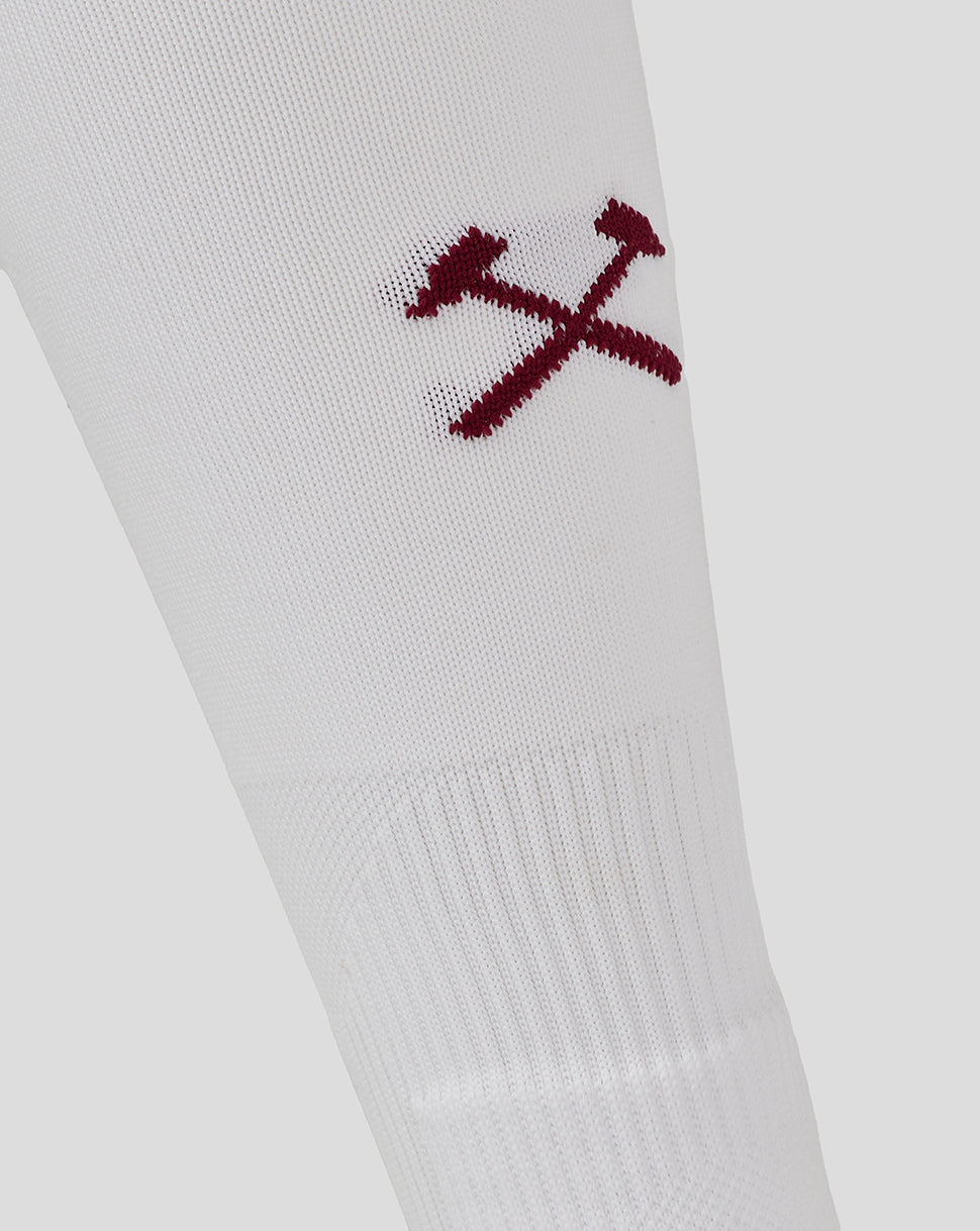 White sock close-up with maroon West Ham crest featuring two crossing hammers embroidery