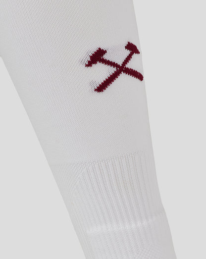 White sock close-up with maroon West Ham crest featuring two crossing hammers embroidery
