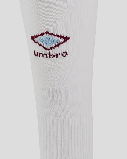 White sock close-up showing maroon Umbro diamond logo with light blue center
