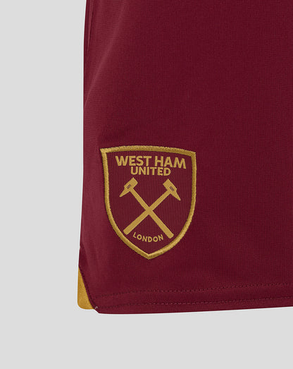 Gold West Ham crest embroidered on burgundy fabric at the shorts hem