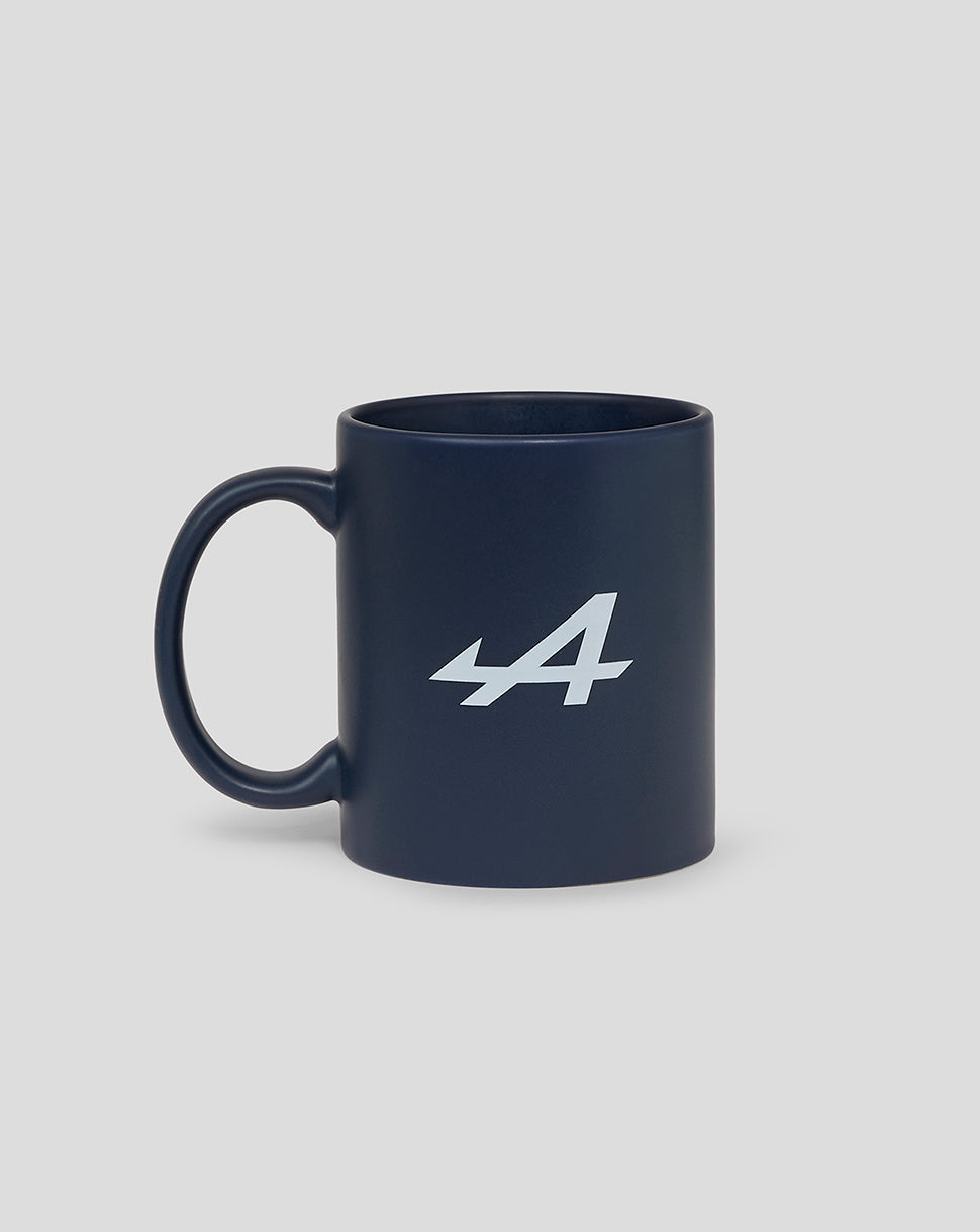 Navy ceramic mug with a white Alpine logo on its side.