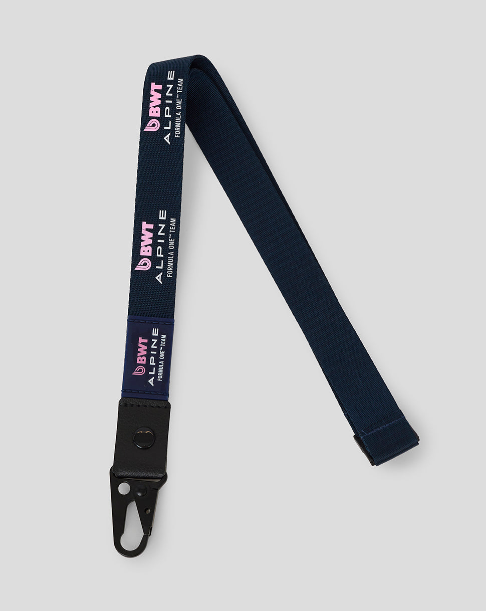 Dark navy BWT Alpine Formula One Team lanyard with pink branding and a black metal clip.