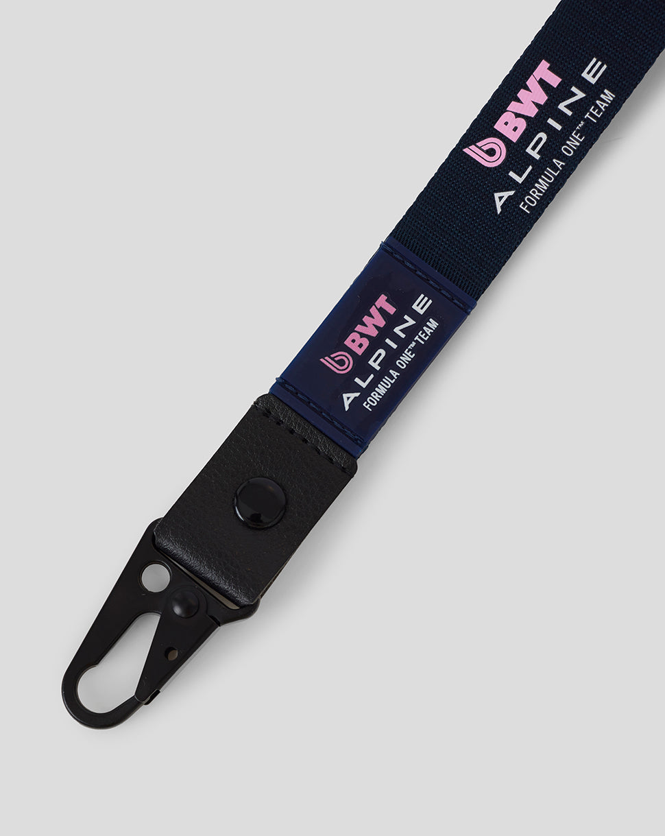 Close up of navy BWT Alpine Formula One Team lanyard showing logo panels and black metal clip.