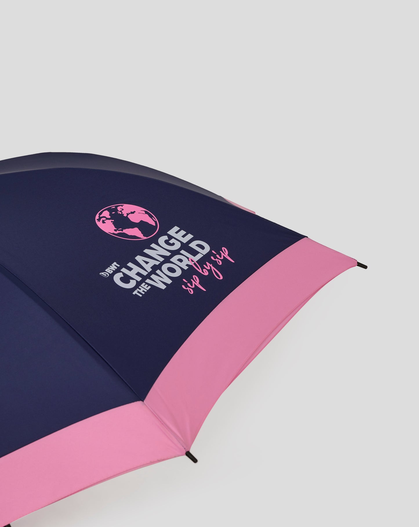 Open navy and pink BWT Alpine umbrella displaying Change the World slogan