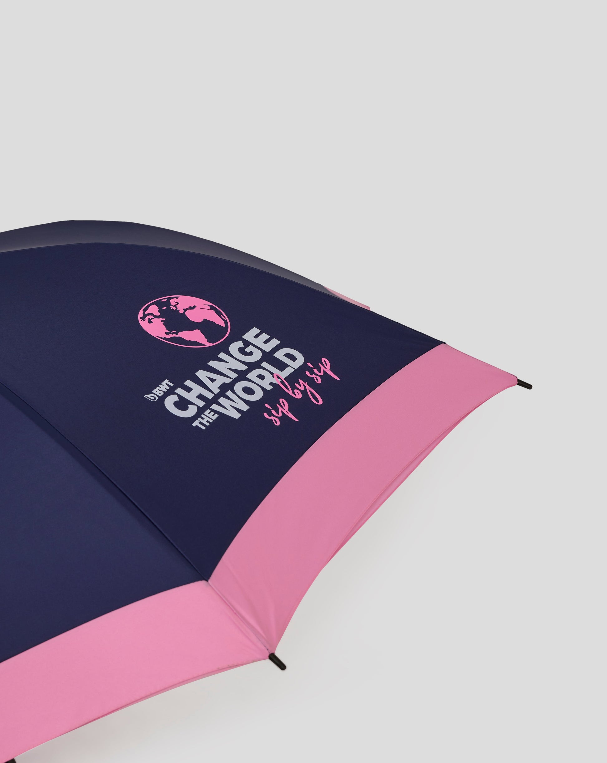 Open navy and pink BWT Alpine umbrella displaying Change the World slogan