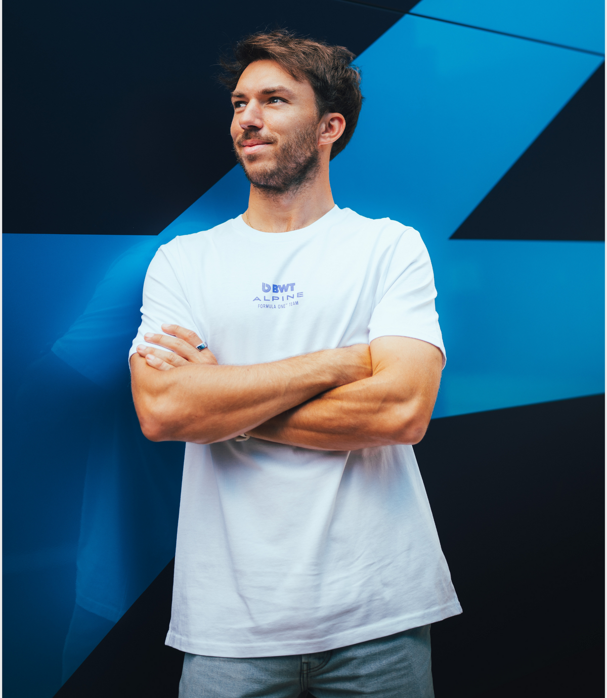 White BWT Alpine Formula One Team core driver T shirt worn by a man with Alpine logo on the chest