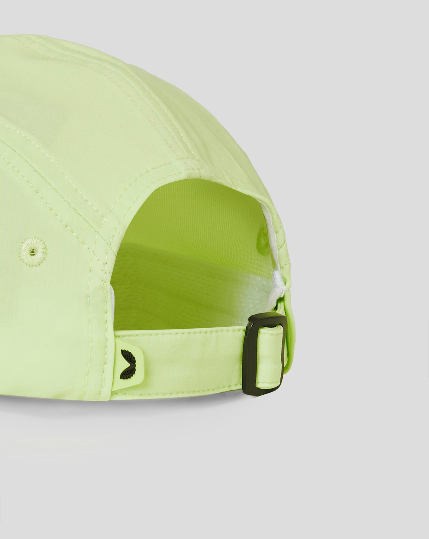 Close-up of lime cap side with a black buckle and branding along the panel