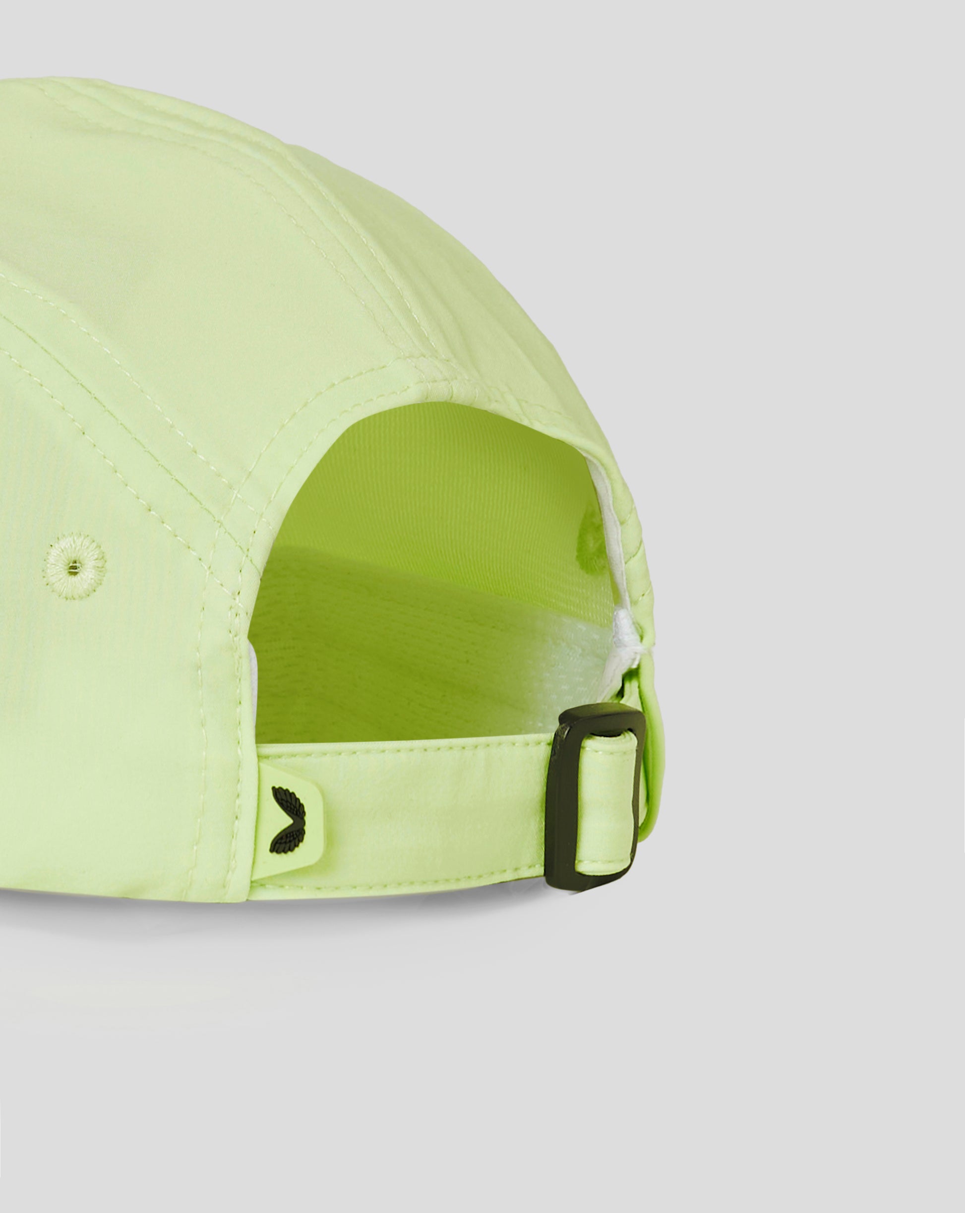 Close-up of lime cap side with a black buckle and branding along the panel