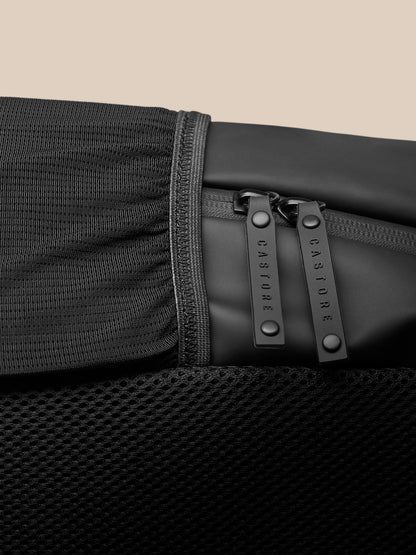 Close up of dual zippers with Castore branded pulls on the black Core Backpack.