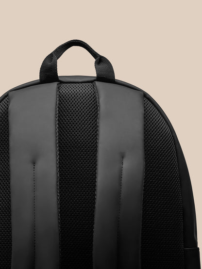 Back view of black Core Backpack showing padded back panel and adjustable padded shoulder straps.