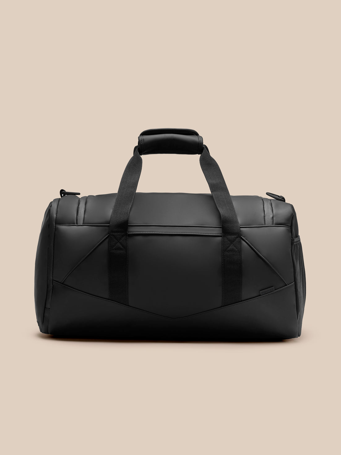 Front view of black Core Holdall with dual top handles and a detachable shoulder strap; Castore logo on front
