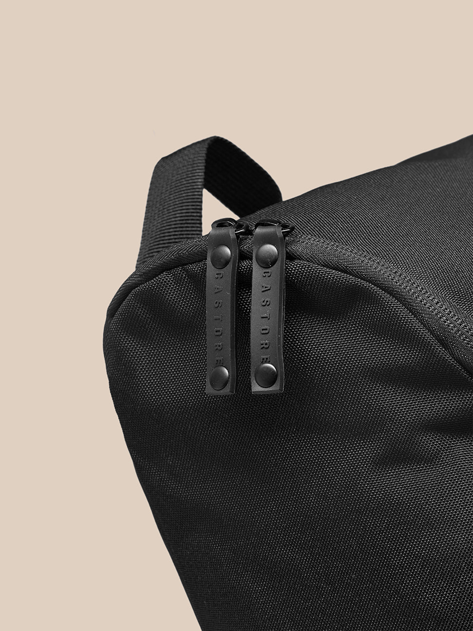 Close-up of black Active Boot Bag showing durable woven fabric and dual zipper pulls with top strap