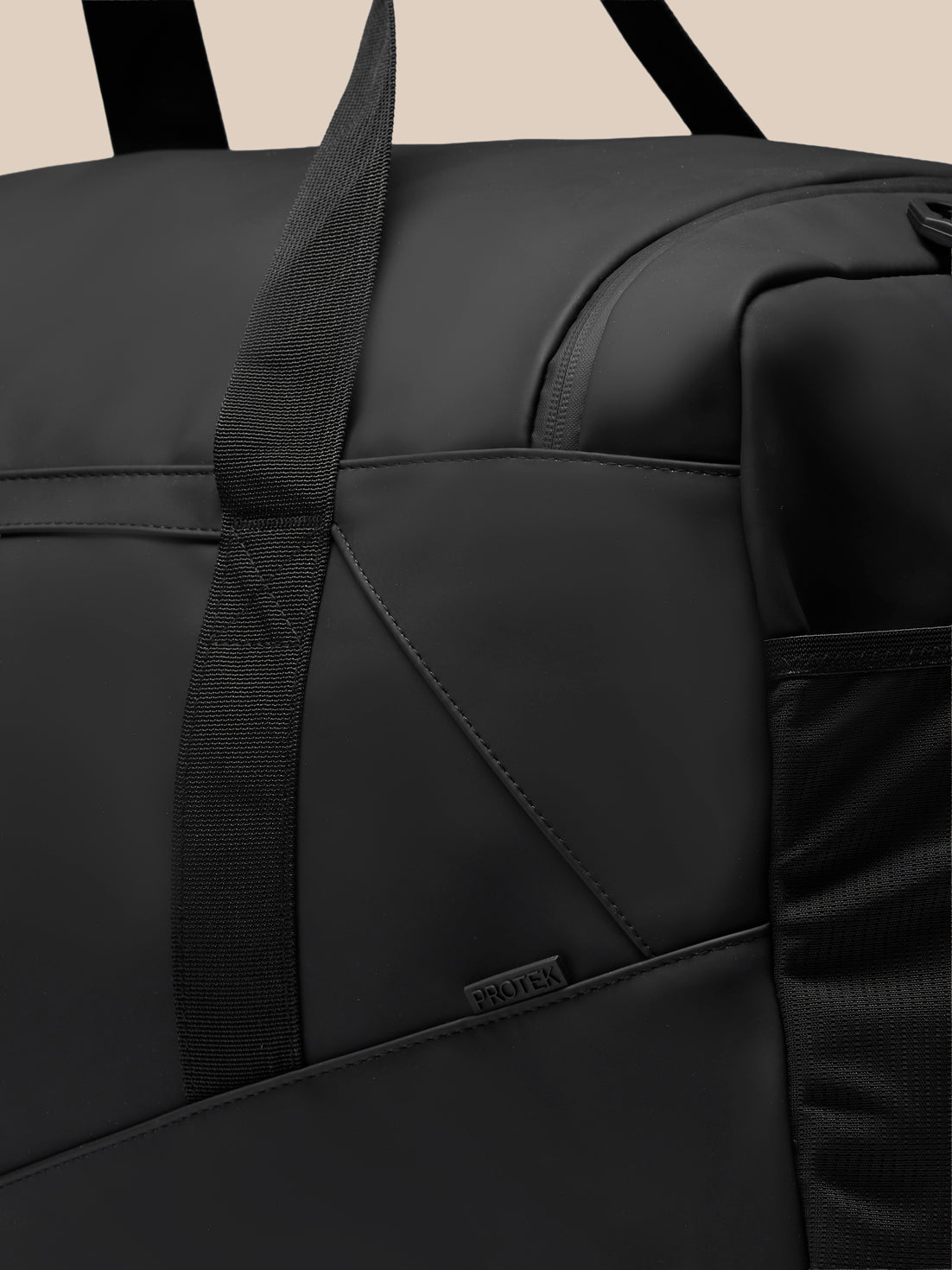 Close-up of black Large Core Holdall highlighting sturdy strap stitched panels and PROTEK badge