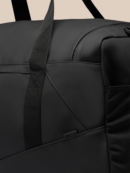 Close-up of black Large Core Holdall highlighting sturdy strap stitched panels and PROTEK badge
