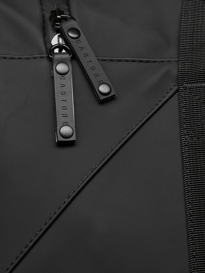Close-up of black holdall zipper pulls on durable material with reinforced stitching and a woven strap edge