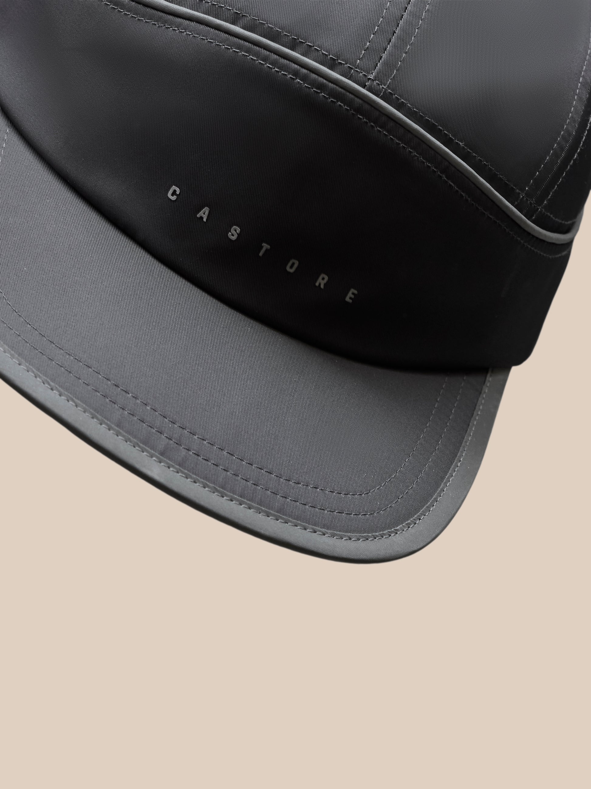 Back view close-up of gunmetal cap showing adjustable strap and orange back fastener