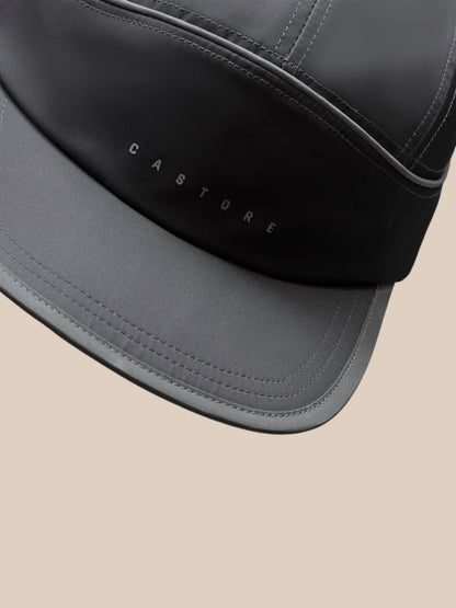 Back view close-up of gunmetal cap showing adjustable strap and orange back fastener