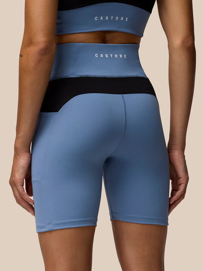 Back view of light blue Apex Training Cycle Shorts with a phone in the side pocket