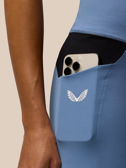Close-up of back pocket on Dove Blue Apex Training Cycle Shorts with phone and Castore logo