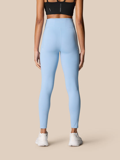 Back view of light blue Zone Training Leggings on a model, high waistband with Castore logo and seam details