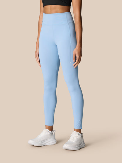 Zone Training Leggings sky blue worn from the back by a model, high waistband with Castore branding
