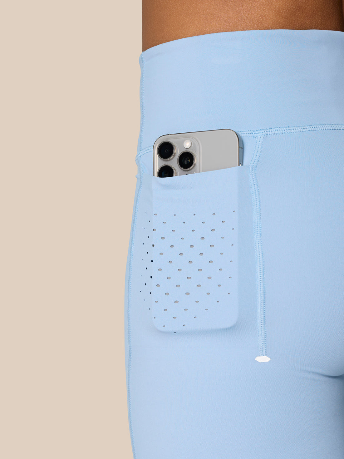 Hip area of Sky Blue Zone Training Leggings with perforated pocket panel and subtle seam lines.
