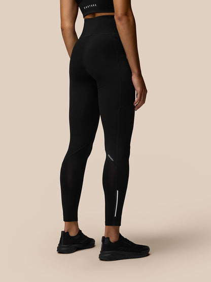Back view of Apex Training Leggings in black on a model with a high waistband and athletic fit