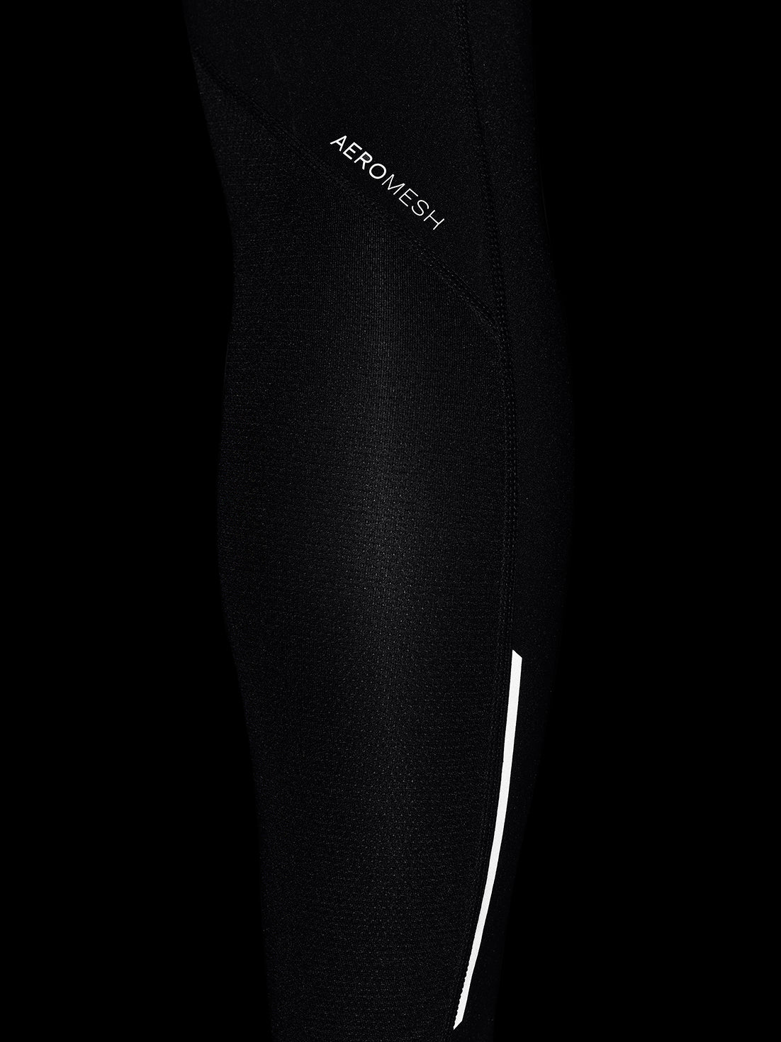 Close-up of black AerMesh fabric on the leggings with a white seam running along the leg