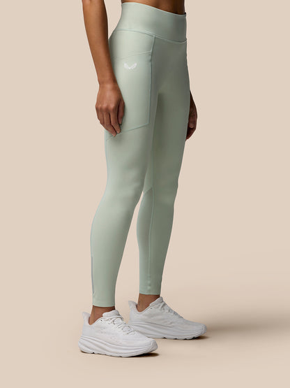 Side view of Sage Apex leggings highlighting side seams and a small logo on the thigh.