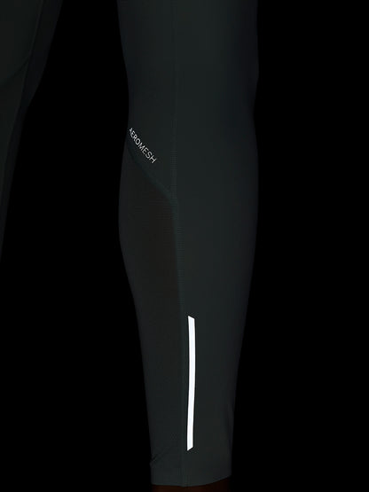 Close-up of Apex Training Leggings showing Aeromesh paneling and a white reflective stripe on the lower leg