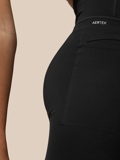 Close-up of black Flow Movement leggings waistband showing AerTek branding and secure fit seam