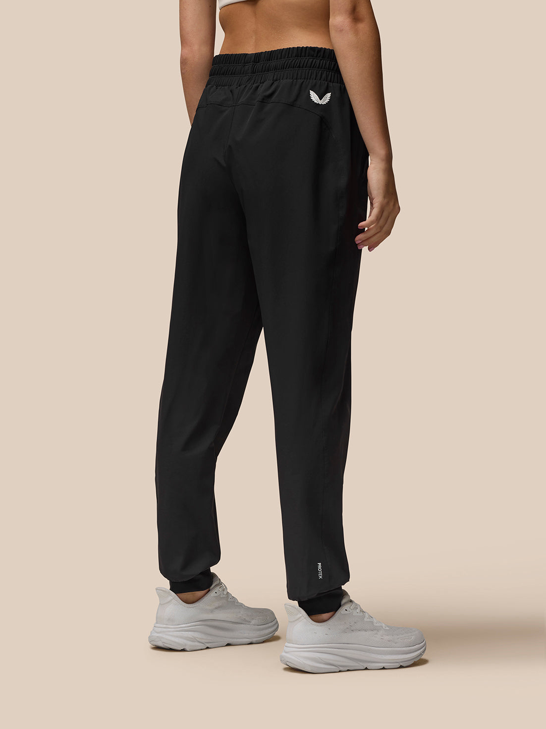 Back view of Flow Training Joggers in black with elastic waistband and Castore logo on the left back leg
