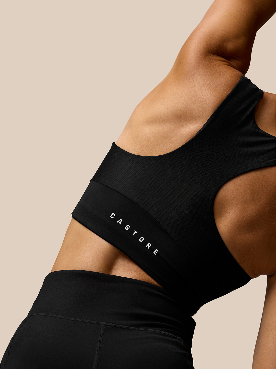 Close up of back detail on black Apex Training Sports Bra showing racer back and Castore logo on the band.