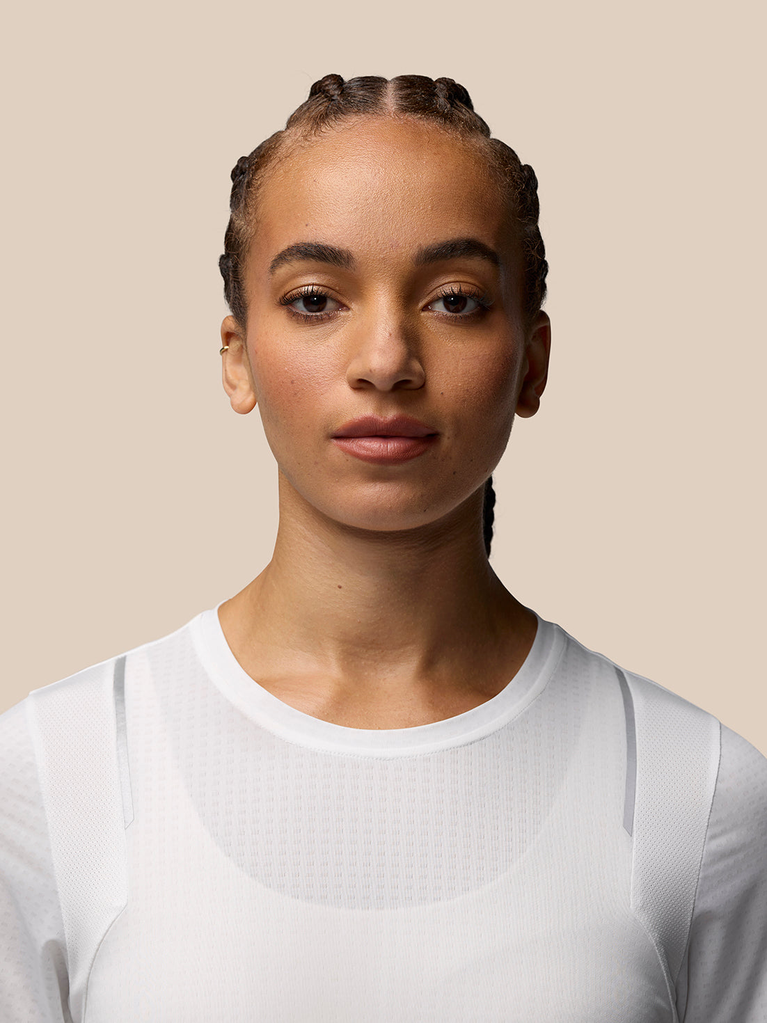 Portrait of a woman in a white Apex Training T Shirt highlighting breathable fabric and crew neckline