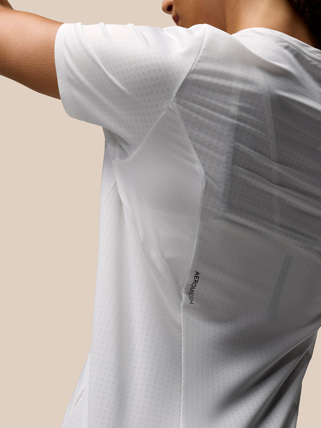 Close up of the shoulder area on a white Apex Training T Shirt showing AeroMesh fabric and panel construction