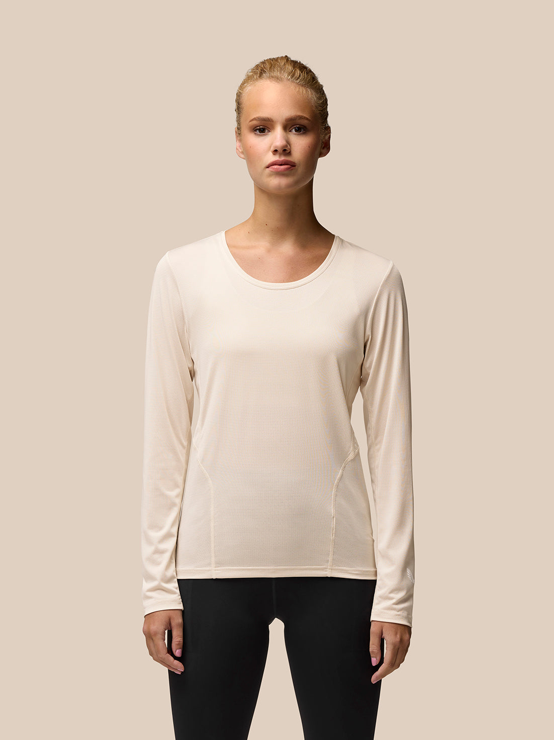 Beige Flow Movement long sleeve tee worn by a model showcasing a clean athletic fit