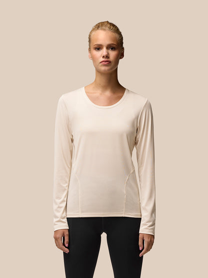 Beige Flow Movement long sleeve tee worn by a model showcasing a clean athletic fit