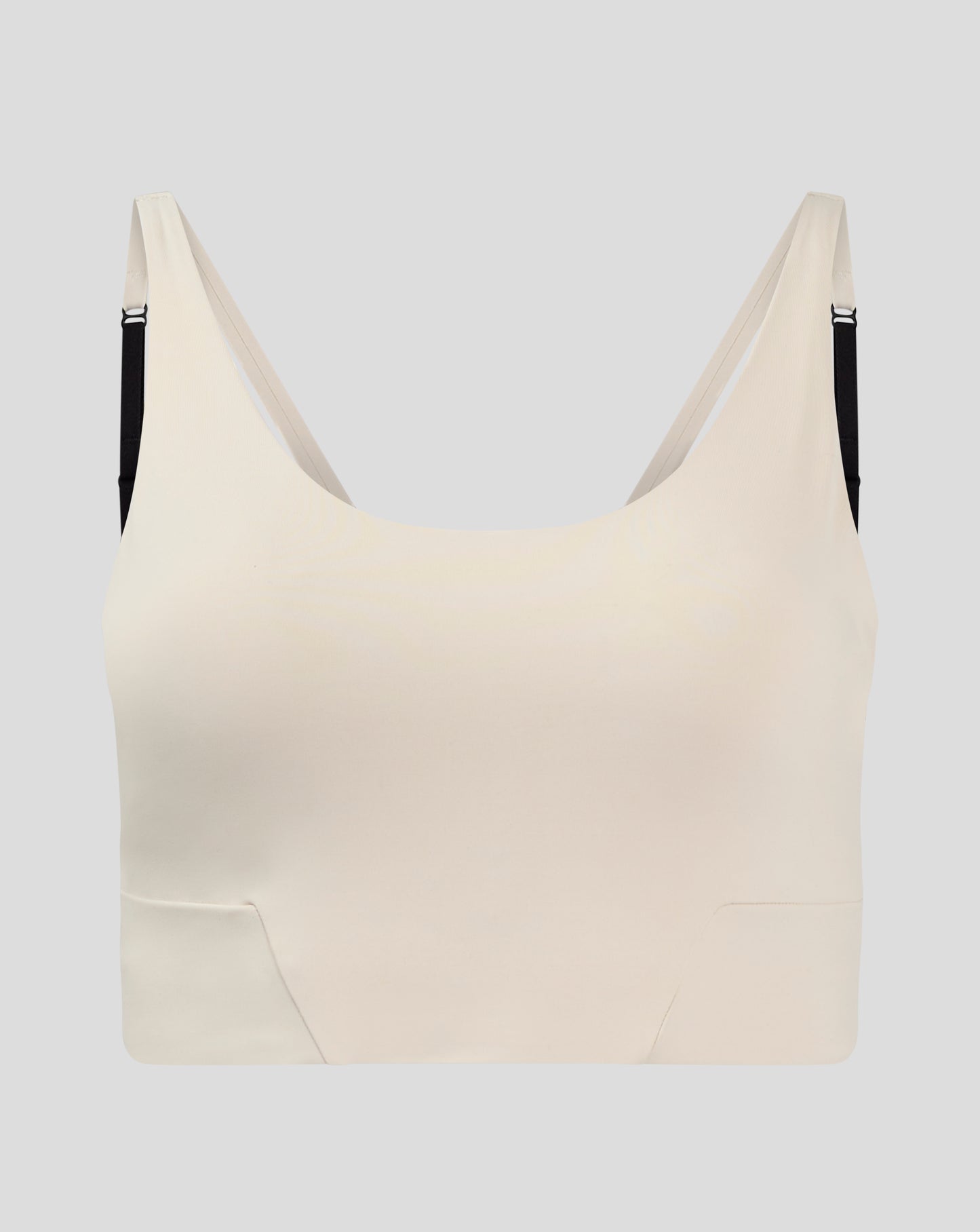 Beige Flow Training cropped sports bra with adjustable straps and removable cups.