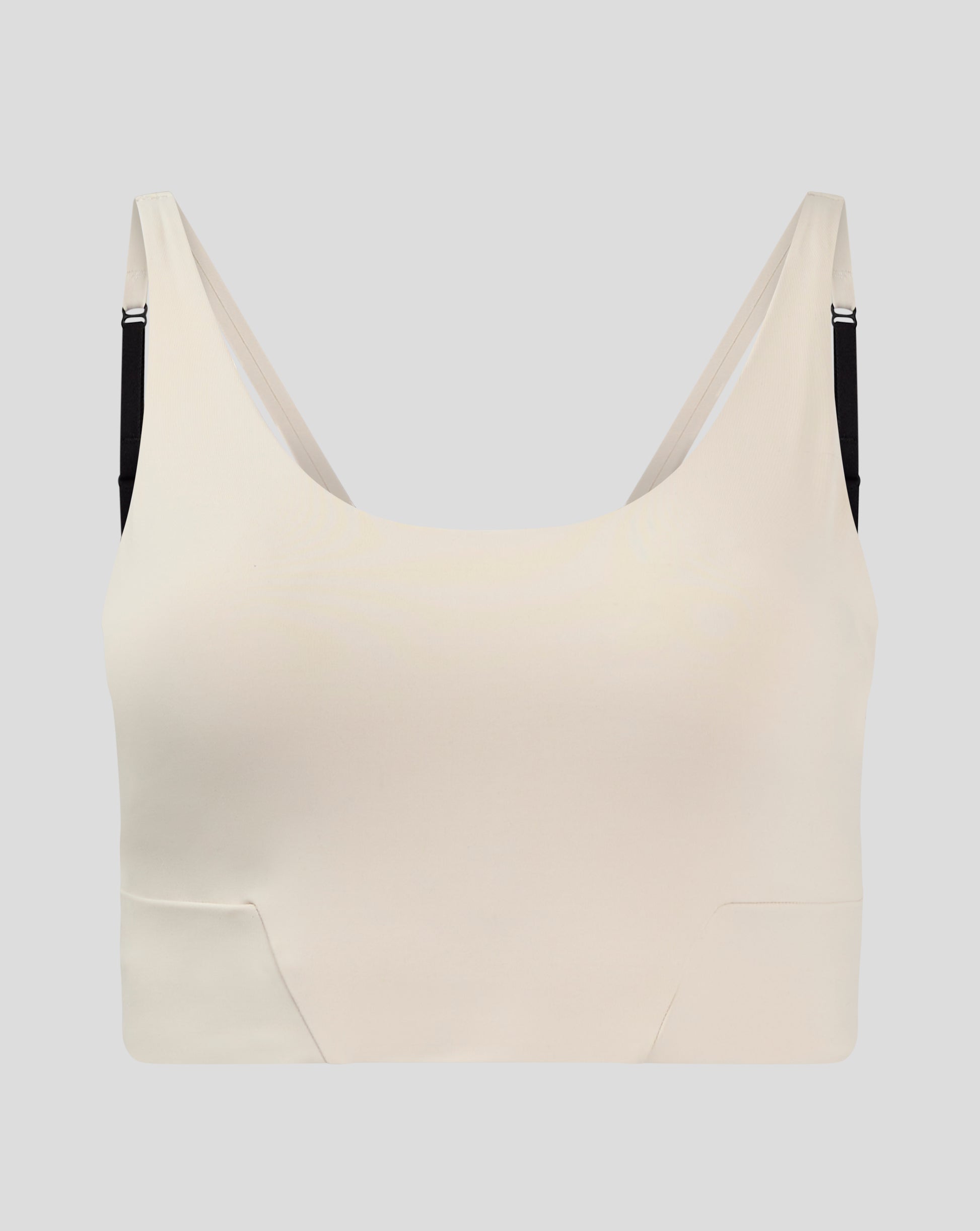 Beige Flow Training cropped sports bra with adjustable straps and removable cups.