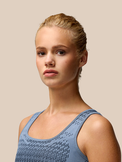 Back view of the Dove Blue Flow Training Seamless Crop Sports Bra showing the racerback and jacquard knit pattern