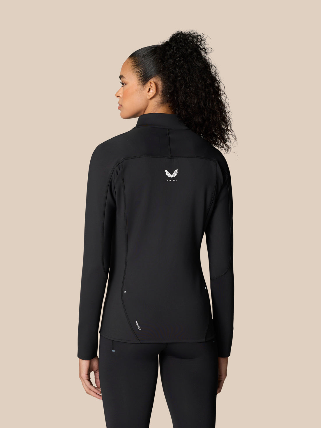 Back view of a black Zone Training Top showing a white crest on the center back and ProTek detailing along the hem.