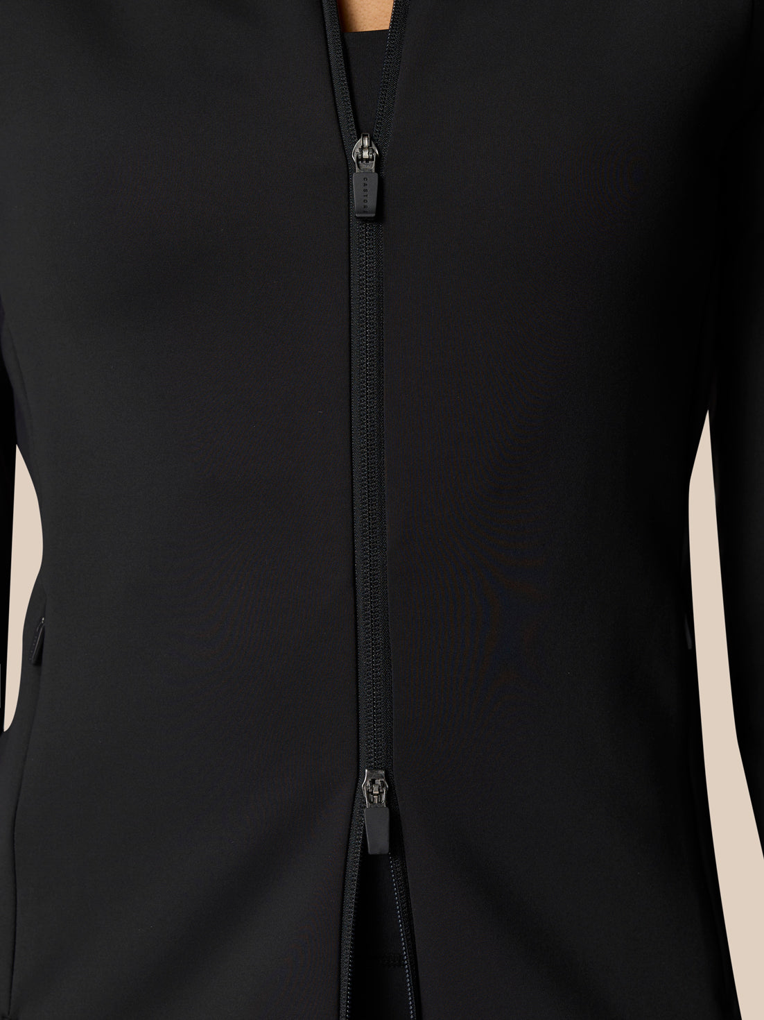 Model wearing a black Zone Training Top full zip jacket with front zipper in a sleek athletic fit