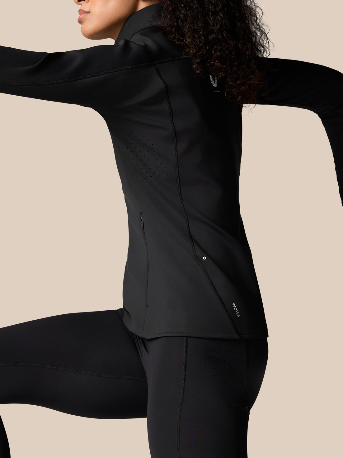 Back view of Zone Training Top Black jacket showing a perforated side panel and small logo.