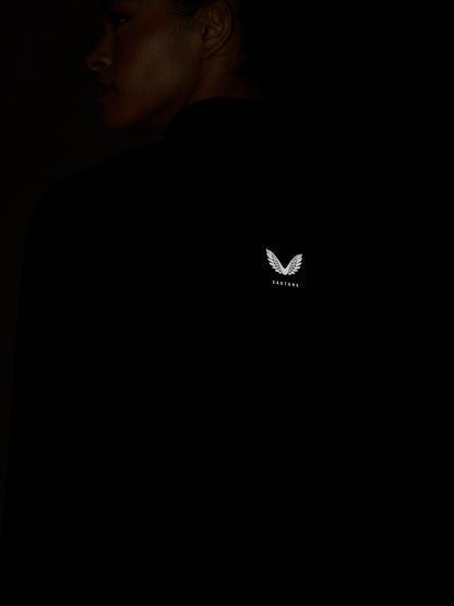 Back view of a black Zone Training Top with a white Castore wing logo on the upper back