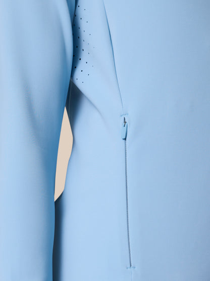 Close-up of the sky blue Zone Training Top showing vent holes and a side zipper.