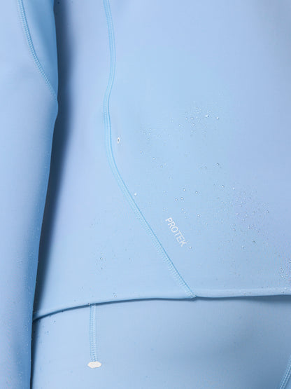 Close-up of fabric with water droplets beading and the ProTek logo on the Zone Training Top.