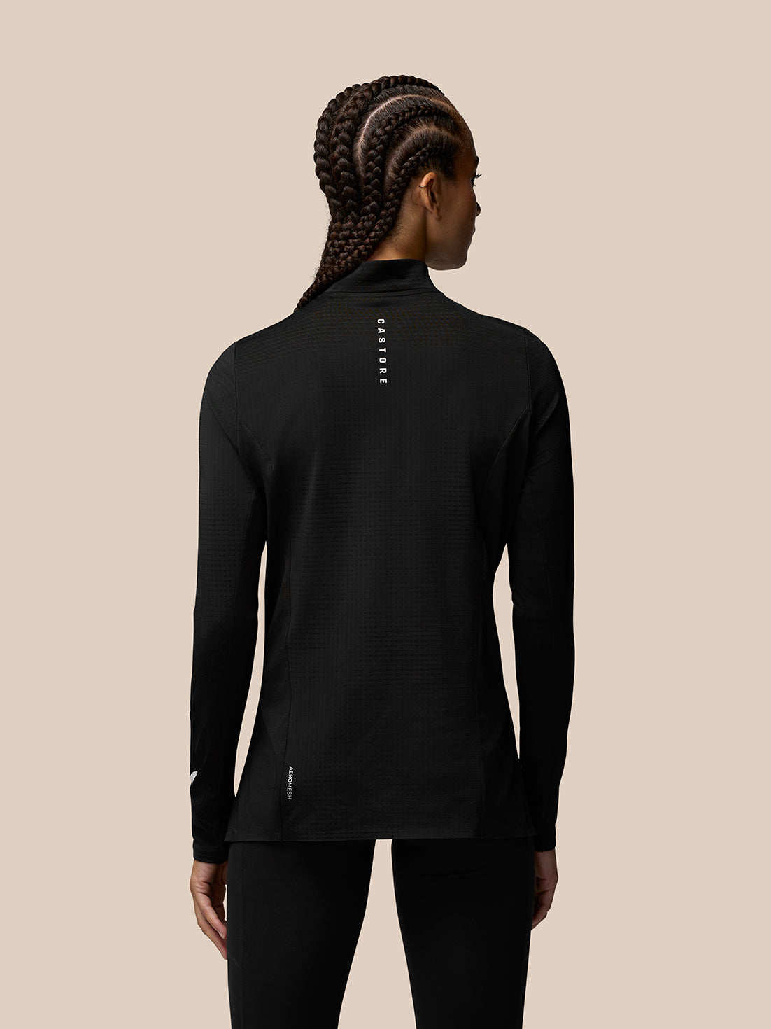 Back view of black Apex Training 1/4 Zip Top showing Castore branding on the back of the left sleeve.