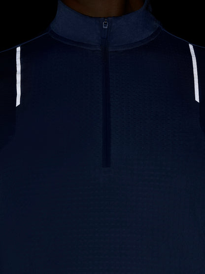 Close up of the front of a dark blue Apex Training quarter zip top with center zipper and funnel collar