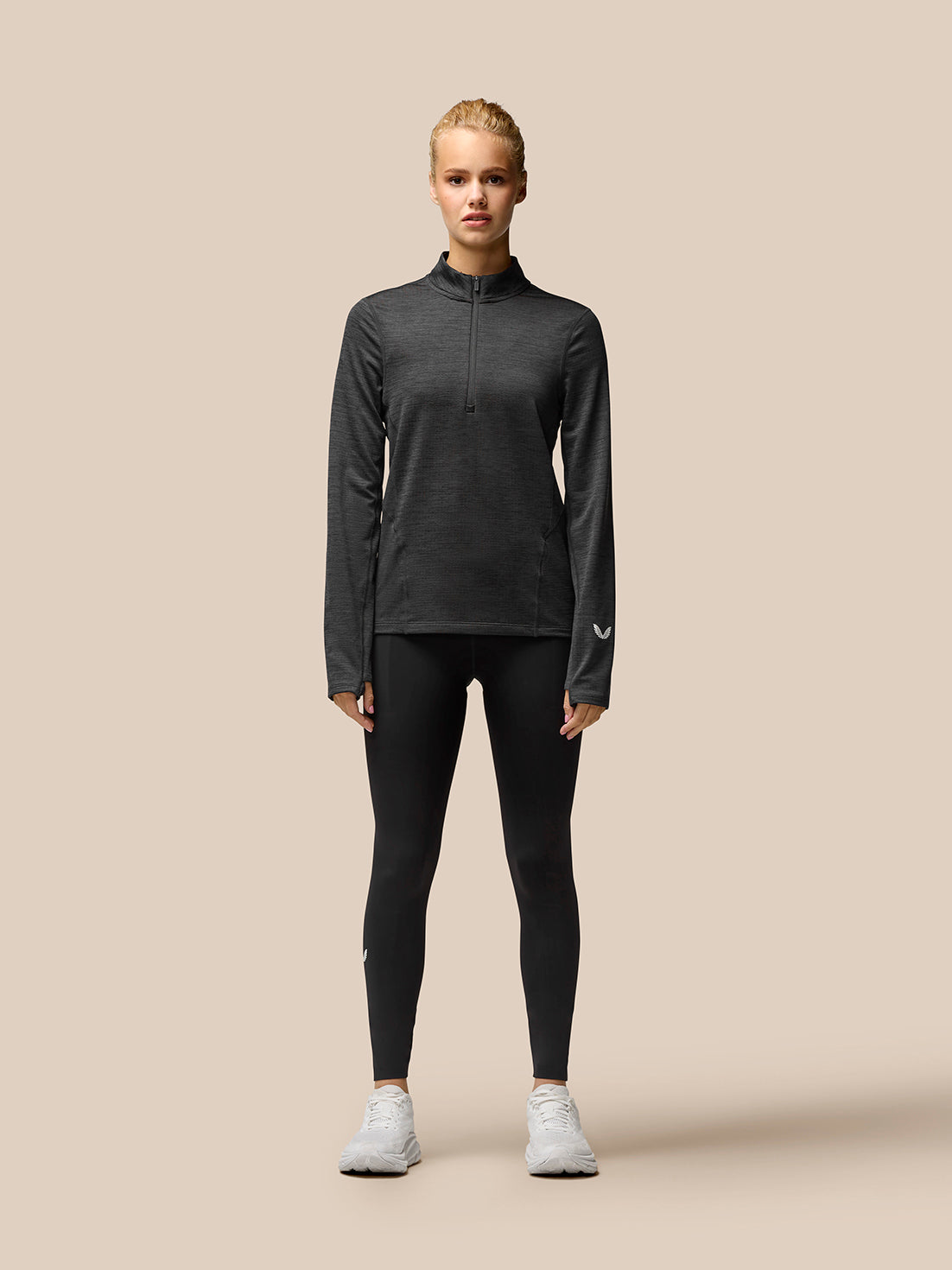 Rear view of Flow Training fleece half zip top on model showing fitted silhouette and back seam details